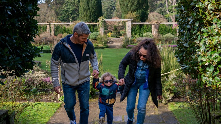Parents and child having fun in the garden
